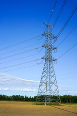 high voltage power line metal support on a blue sky background