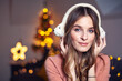 © Gabi Moisa - Beautiful young smiling woman at Christmas listening to music