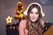 © Gabi Moisa - Beautiful young smiling woman at Christmas listening to music