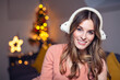 © Gabi Moisa - Beautiful young smiling woman at Christmas listening to music