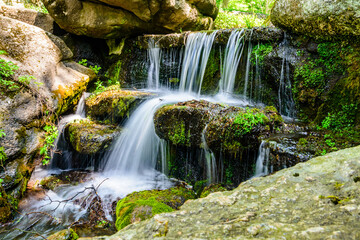 Wall Mural - Beautiful waterfall on small river in a park