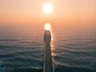 Wall Mural - old port pier in pondicherry rock beach during the sunset