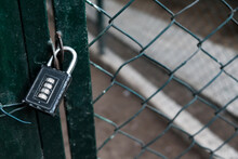 Closed Entrance With Code Padlock On A Metal Wire Fence. Private Restricted Area With Prohibited Access. Protected Place On Lockdown During Coronavirus Outbreak. Prison Or Jail Concept, Classified.