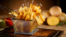 French Fries Close Up With Condiments On Dark Background