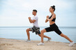 © New Africa - Couple doing exercise together on beach. Body training