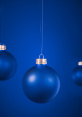 Wall Mural - Light blue round matt Christmas ball. Christmas ornament standing on blue background.