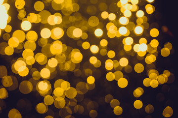 Gold bokeh from light in water with black background