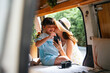 © THESHOTS.CO - Mother kissing her child in recreational vehicle home car.