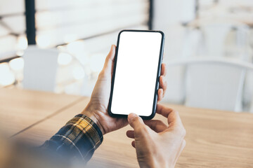 cell phone blank white screen mockup.woman hand holding texting using mobile on desk at coffee shop.background empty space for advertise.work people contact marketing business,technology