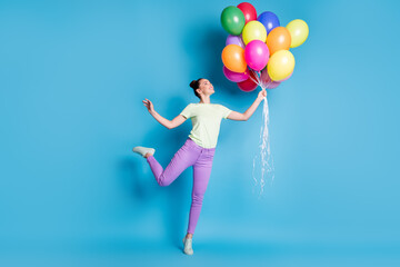 Poster - Full length body size photo of girl keeping pile of colorful air balloons smiling standing tiptoes isolated on bright blue color background