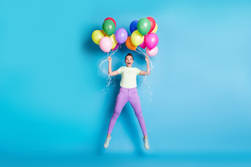 Sticker - Full length body size photo of amazed crazy girl jumping keeping air balloons shouting loudly isolated on vivid blue color background