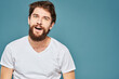 © SHOTPRIME STUDIO - emotional man gesturing with hands lifestyle fun white t-shirt blue isolated stock