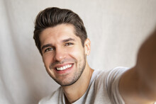 Portrait Of A Young Attractive Man Doing A Selfie With A Gorgeous Smile And Perfect Teeth 