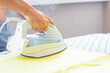 © Владислав Легір - Woman hand ironing a shirt, on cloth background. Closeup of woman ironing clothes on ironing board