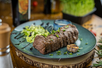 Wall Mural - grilled filet mignon with sauce and garlic on plate