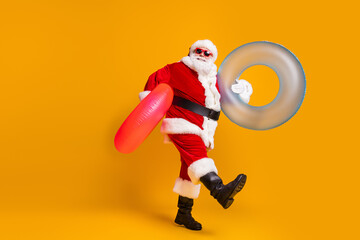 Sticker - Full size profile side photo of white grey hair bearded santa claus rest x-mas christmas time go hold rubber circle wear sunglass headwear boots isolated bright shine color background