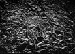 Aluminium foil texture. Dark crumpled metal background