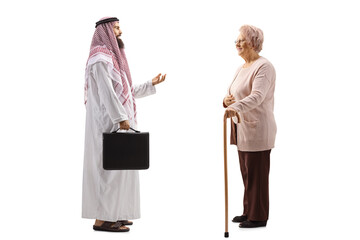 Poster - Full length profile shot of an arab businessman in a thobe talking to an elderly lady