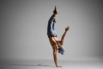 Poster - Topless muscualr man in jeans doing a handstand