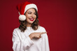 © Drobot Dean - Happy cheery young woman in christmas santa hat