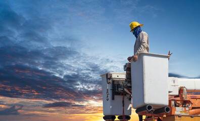 electricians work with high voltage electricity on the hydraulic bucket and copy space