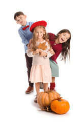 Canvas Print - Cute little children in autumn clothes and with pumpkins on white background