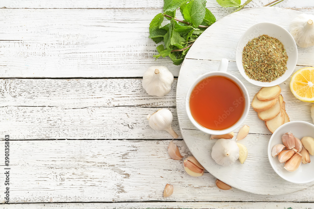 Cup of healthy garlic tea on table