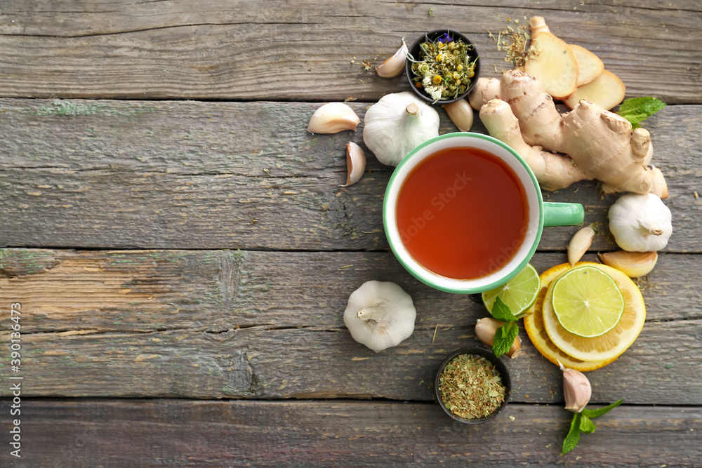 Cup of healthy garlic tea on table