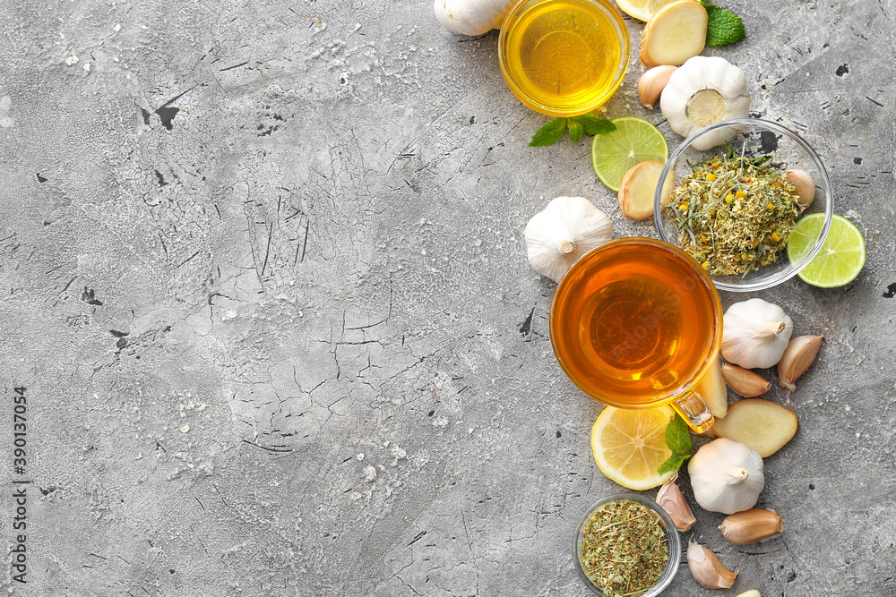Cup of healthy garlic tea on grunge background