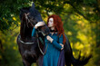 cosplay Braveheart red curly girl with a horse in the woods