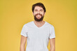 © SHOTPRIME STUDIO - Bearded man on emotions white t-shirt fun lifestyle yellow background