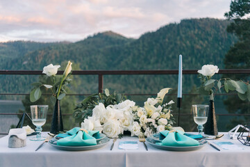 Wedding table setting for an evening dinner for two in Altai