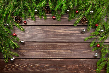 Winter holidays frame with fir tree branches, christmas decorations, cones and berries