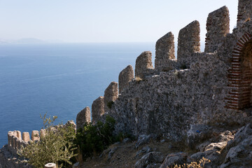 Old fortress stone wall on blue sea background.