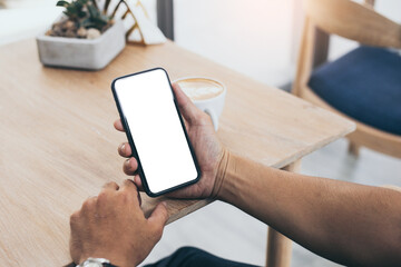 cell phone blank white screen mockup.man hand holding texting using mobile on desk at office.background empty space for advertise.work people contact marketing business,technology