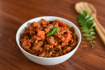 Wall Mural - Spicy beef curry. Goan style beef vindaloo. Traditional Indian Lamb or beef curry . spicy Beef curry gravy popular in Kerala Sri Lankan Goa for Appam, Parotta porotta in India.