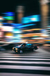 © YUTO YAMADA - Blurred motion of taxi driving on city street at night