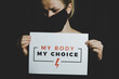 © Longfin Media - Woman holding a sign 'My Body, My Choice'. Protest against tightening of the abortion law in Poland. Nationwide women's strike. Wearing protective face mask against COVID-19 Coronavirus.