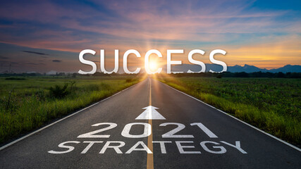 New year 2021 or start straight concept.word 2021 and strategy written on the road of asphalt road at sunset.Concept of target and challenge or career path,success business,opportunity and change