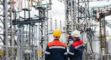 Two Specialist Electrical Substation Engineers Inspect Modern High-voltage Equipment. Energy. Industry