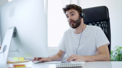 Wall Mural - Young man at home having video call working with computer