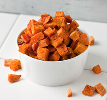 Close Up Of Coconut Oil Roasted Sweet Potatoes Served In Bowl