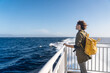 © Pietro Karras/Stocksy - Dreamy female standing on deck in wind