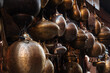 © Pietro Karras/Stocksy - Beautiful shiny ancient vessels hanging for sale