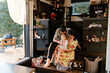 © Ryan Tuttle/Stocksy - Young Family living in a Tiny Home on Wheels