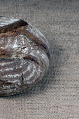 Wall Mural - round rye bread with a cracked crust on a canvas