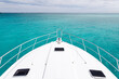 © Neal Pritchard/Stocksy - The bow of a luxury yacht sitting in clean clear turquoise ocean waters off the coast of Perth