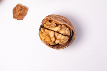 Wall Mural - Walnuts isolated on white background. Walnut kernels and whole walnuts