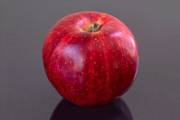 red apple on black background