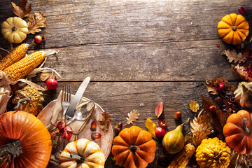 Wall Mural - thanksgiving board - table setting with silverware and pumpkins on aged wooden plank